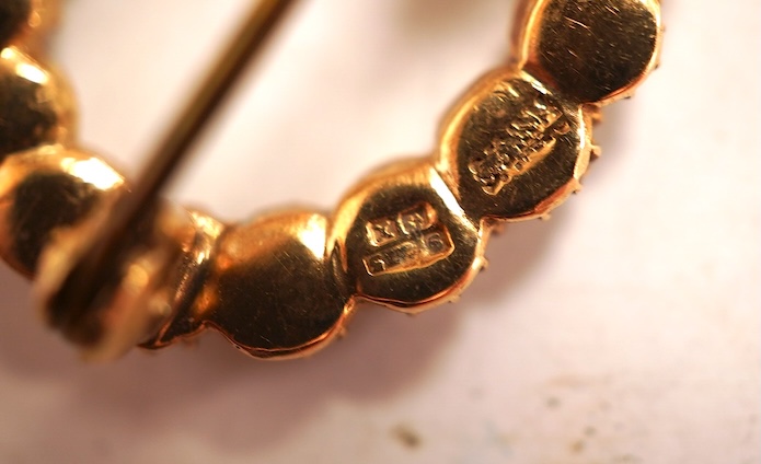 A cabochon amethyst and half pearl brooch, mounted in 9ct gold, length 3.7cm, British hallmarks, gross weight approximately 9.5 grams; and a 9ct half pearl wreath brooch, length 2.1cm, British hallmarks, gross weight 2 g